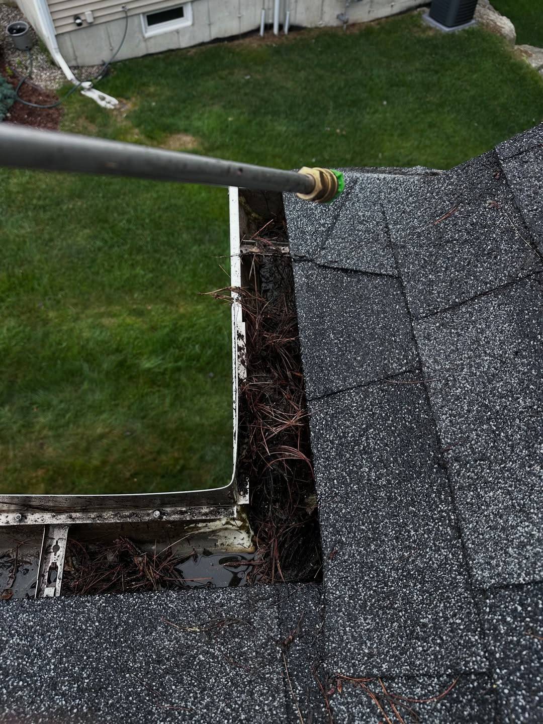 Before: A gutter corner clogged with debris