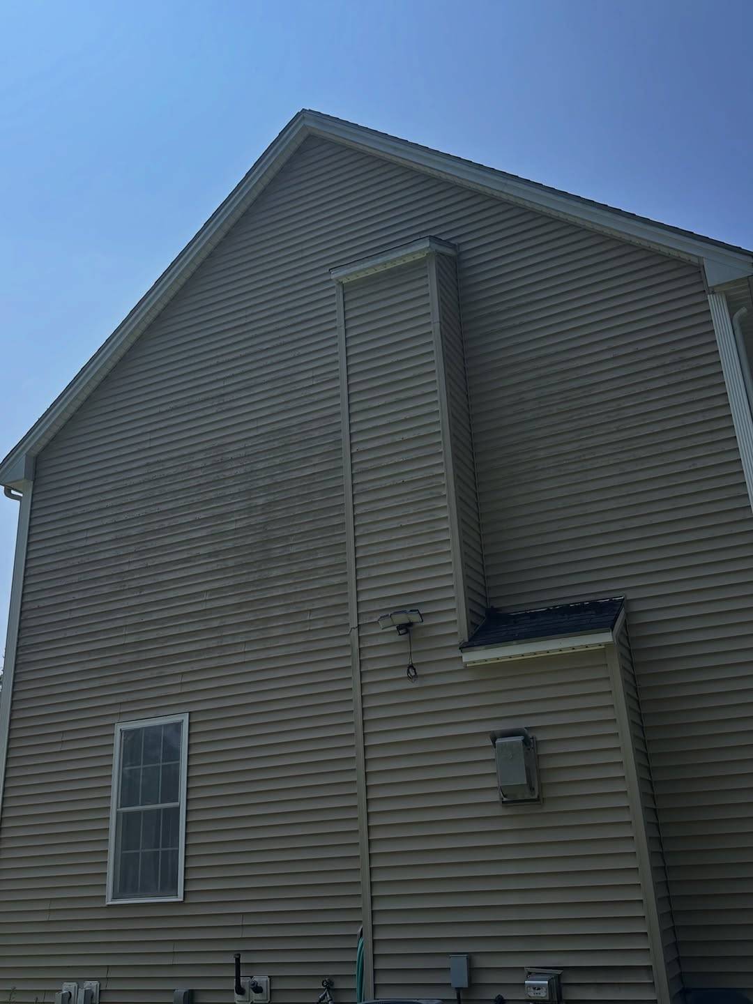 Before: Gable wall with green mildew patches
