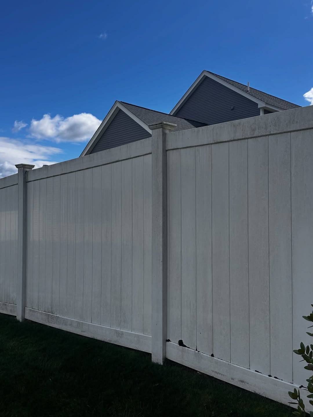 Before: A white vinyl fence with dirt along the bottom