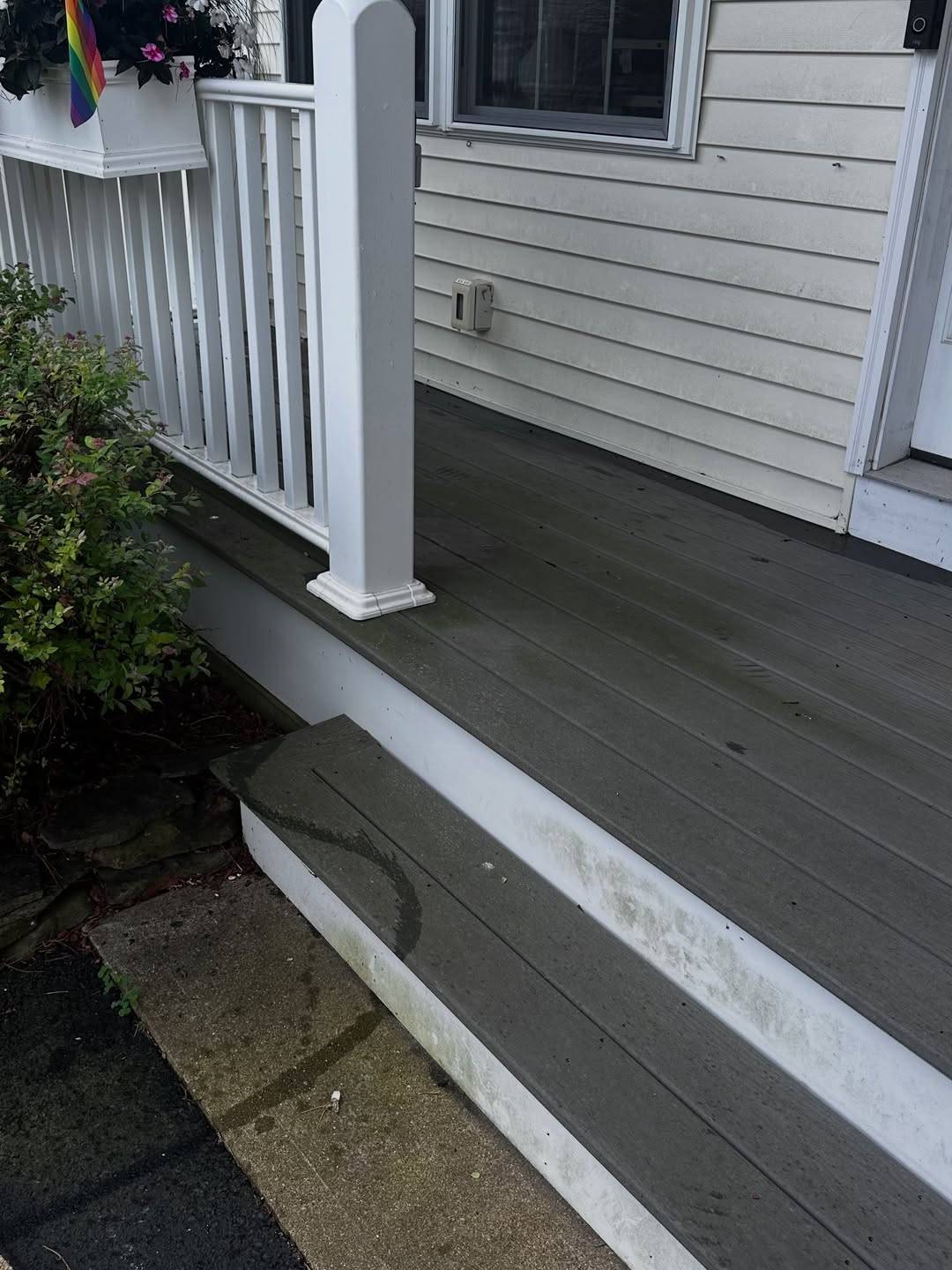 Before: A porch edge with dirt on the step